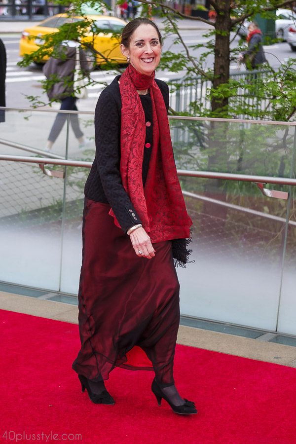 A red floral print scarf paired with a black top | 40plusstyle.com