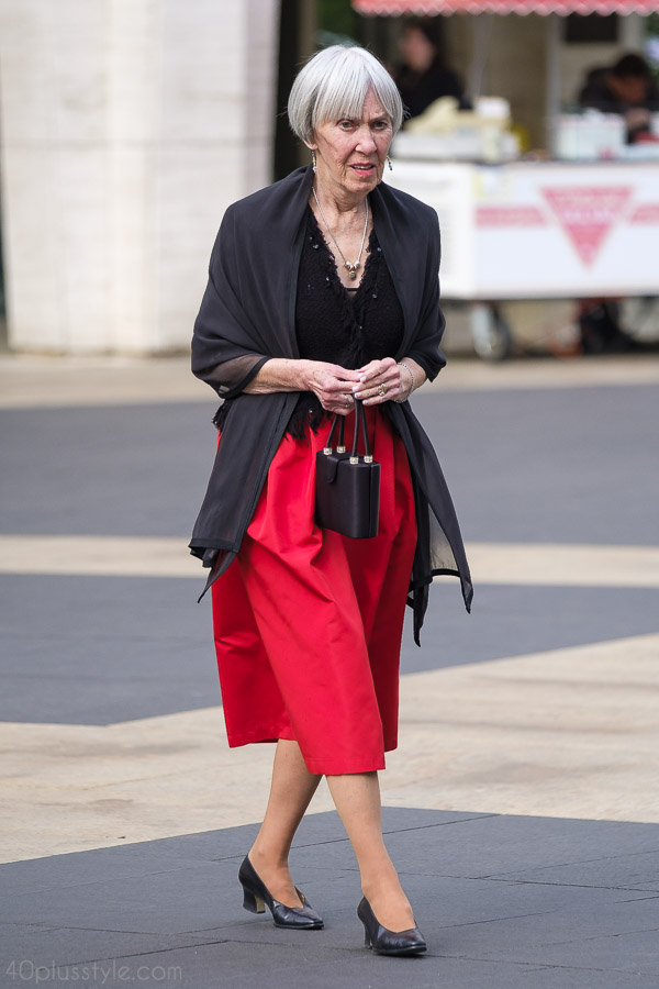 Chic sheer wrap styled with a red skirt for a modish ensemble | 40plusstyle.com