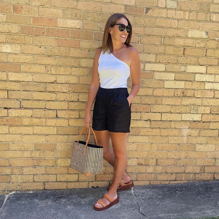 Karen in one shoulder tank top and linen shorts | 40plusstyle.com