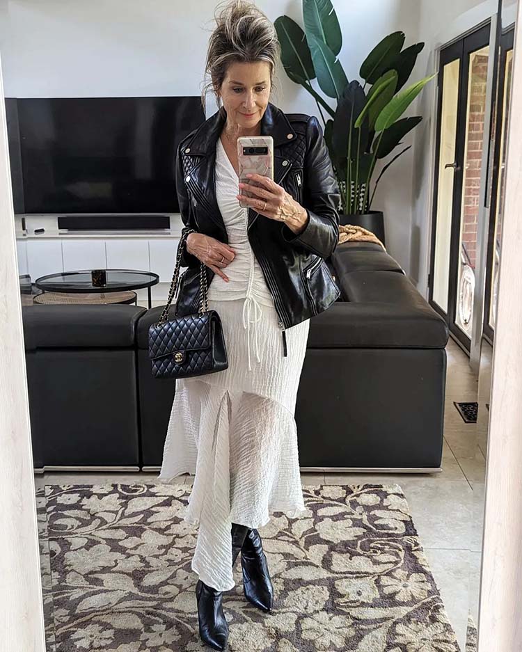 Suzie in moto jacket, ruched top, asymmetric skirt and boots | 40plusstyle.com